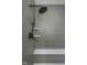 Stylish shower with gray tiling, sleek fixtures, and a built-in bench at 17368 Pinellas Ave, Westfield, IN 46074