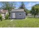 Backyard view of a home with gray vinyl siding and a small yard at 2218 N Arsenal Ave, Indianapolis, IN 46218