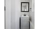 Modern bathroom with a gray vanity, black faucet, and framed mirror at 2218 N Arsenal Ave, Indianapolis, IN 46218