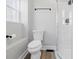 Bathroom featuring a low-flow toilet and tiled shower with a glass door at 2218 N Arsenal Ave, Indianapolis, IN 46218