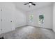 Bedroom with carpet, ceiling fan and windows showcasing neighborhood views at 2218 N Arsenal Ave, Indianapolis, IN 46218