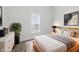 Well-lit bedroom with a comfortable bed, side tables, and modern decor at 2218 N Arsenal Ave, Indianapolis, IN 46218