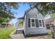 Charming home with gray siding, black shutters, and a bright yellow front door at 2218 N Arsenal Ave, Indianapolis, IN 46218