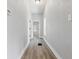 Bright hallway with wood-look floors, white trim, and neutral paint at 2218 N Arsenal Ave, Indianapolis, IN 46218