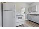Bright kitchen features a white refrigerator, oven, and grey cabinets with durable countertops at 2218 N Arsenal Ave, Indianapolis, IN 46218