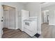 Kitchen with a white refrigerator and oven adjacent to open doorway at 2218 N Arsenal Ave, Indianapolis, IN 46218