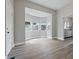 Bright living room featuring new gray vinyl floors, neutral walls, and bay window at 2218 N Arsenal Ave, Indianapolis, IN 46218