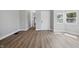 Bright living room featuring new gray vinyl floors, neutral walls, and multiple windows at 2218 N Arsenal Ave, Indianapolis, IN 46218
