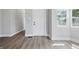 Bright living room featuring new gray vinyl floors and multiple windows providing natural light at 2218 N Arsenal Ave, Indianapolis, IN 46218
