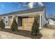 View of a grey home featuring a covered patio area, complimented by lush landscaping, with blue skies overhead at 3922 Holly Brook Dr, Westfield, IN 46062