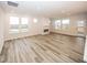 Spacious living room featuring modern wood flooring, a sleek fireplace, and abundant natural light at 3922 Holly Brook Dr, Westfield, IN 46062