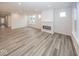 Bright living area showcasing modern flooring, a cozy fireplace, and multiple windows at 3922 Holly Brook Dr, Westfield, IN 46062
