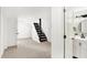 Bright basement featuring neutral carpet, fresh white walls, and a convenient adjacent half bathroom at 4360 Guilford Ave, Indianapolis, IN 46205