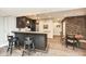 Basement wet bar with dark cabinets and copper accents at 520 Bridgemont Ln, Carmel, IN 46032
