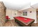 Basement game room with pool table and stone wall at 520 Bridgemont Ln, Carmel, IN 46032