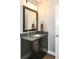 Bathroom with dark vanity and a framed mirror at 520 Bridgemont Ln, Carmel, IN 46032