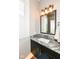 Elegant bathroom with granite countertop, modern vanity, and frameless mirror at 520 Bridgemont Ln, Carmel, IN 46032