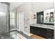 Bathroom with a walk-in shower, granite countertop, and dark vanity at 520 Bridgemont Ln, Carmel, IN 46032