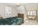 Comfortable bedroom with a rustic bed, sitting area and window at 520 Bridgemont Ln, Carmel, IN 46032