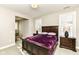 Spacious bedroom with a dark wood bed frame and window shutters at 520 Bridgemont Ln, Carmel, IN 46032