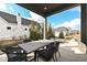 Covered patio features an outdoor dining area and a brick fire pit, perfect for entertaining guests at 520 Bridgemont Ln, Carmel, IN 46032