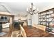 Open concept dining room with kitchen view and rustic wooden table at 520 Bridgemont Ln, Carmel, IN 46032