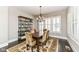 Bright dining room features a rustic table, chandelier, and built-in shelving at 520 Bridgemont Ln, Carmel, IN 46032