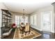 Bright dining room features a rustic table, chandelier, and built-in shelving at 520 Bridgemont Ln, Carmel, IN 46032