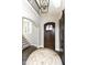 Elegant entryway with a circular rug and hardwood floors at 520 Bridgemont Ln, Carmel, IN 46032