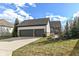 Attached two-car garage featuring neutral siding with brick veneer and well-maintained landscaping at 520 Bridgemont Ln, Carmel, IN 46032