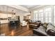 Open concept kitchen with island, stainless steel appliances, and hardwood floors at 520 Bridgemont Ln, Carmel, IN 46032