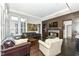 Spacious living room with a fireplace, dark hardwood floors, and comfy seating at 520 Bridgemont Ln, Carmel, IN 46032