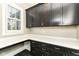 Functional home office with dark cabinetry, white countertops, and built-in shelving at 520 Bridgemont Ln, Carmel, IN 46032