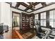 Home office with built-in shelving and hardwood floors at 520 Bridgemont Ln, Carmel, IN 46032
