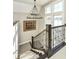 Elegant staircase with dark wood railings and chandelier at 520 Bridgemont Ln, Carmel, IN 46032