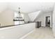 Open upper hallway with chandelier and view to another room at 520 Bridgemont Ln, Carmel, IN 46032