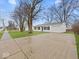 Exterior view of home including a long driveway, sidewalk, and curb appeal at 605 Amos Rd, Shelbyville, IN 46176