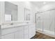 Bathroom showcasing a double sink vanity with quartz countertop and a glass enclosed shower at 7840 Magnolia St, New Palestine, IN 46163