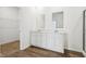 Bathroom featuring granite vanity top, double sinks, and closet at 7840 Magnolia St, New Palestine, IN 46163