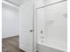 Clean white bathroom featuring a tub and shower combo, bright and ready for a relaxing bath at 7840 Magnolia St, New Palestine, IN 46163