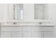 A stylish bathroom features double sinks with quartz countertops and modern fixtures at 7840 Magnolia St, New Palestine, IN 46163