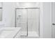 Bathroom featuring quartz countertop, sleek vanity, and modern glass-enclosed shower stall at 7840 Magnolia St, New Palestine, IN 46163