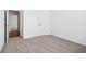 Bedroom featuring neutral carpet flooring and a closet and a transition to another room at 7840 Magnolia St, New Palestine, IN 46163