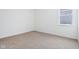 The bedroom has neutral carpet, white walls and a window at 7840 Magnolia St, New Palestine, IN 46163