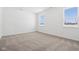 An airy bedroom has carpet, white walls and two windows at 7840 Magnolia St, New Palestine, IN 46163