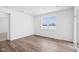 Sunlit bedroom with wood-look floors features a large window and sliding glass doors at 7840 Magnolia St, New Palestine, IN 46163