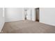 The bedroom features neutral carpet, white walls and a doorway at 7840 Magnolia St, New Palestine, IN 46163