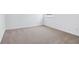 A bedroom with light-colored carpet flooring and an electrical outlet on a wall at 7840 Magnolia St, New Palestine, IN 46163