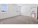 An airy bedroom has carpet, white walls and two windows at 7840 Magnolia St, New Palestine, IN 46163