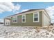 Rear view of the green home with a covered patio, showing the roof at 7840 Magnolia St, New Palestine, IN 46163
